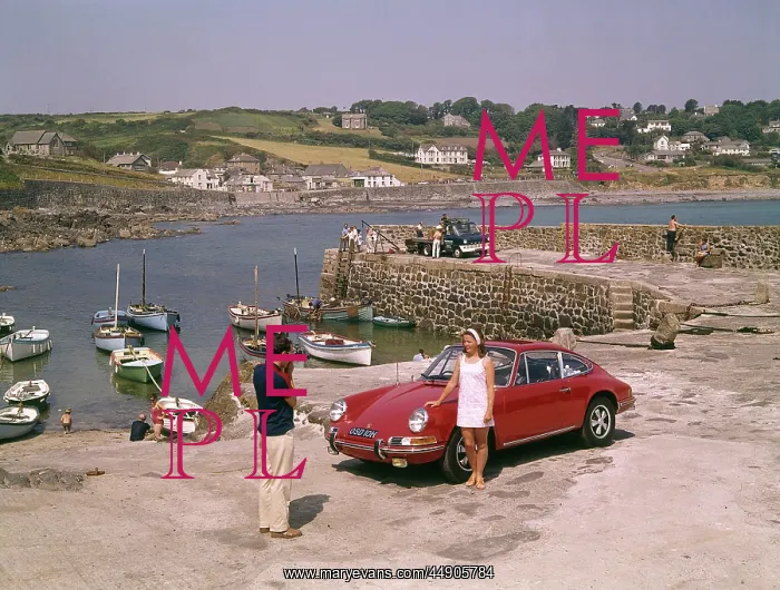  : Couple with red car at Coverack, Cornwall