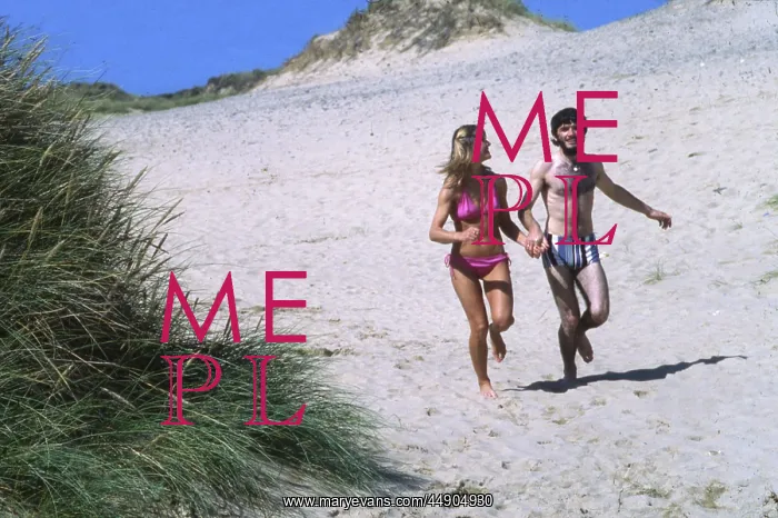 : Couple running on a beach, West Country : Couple running on a beach, West Country