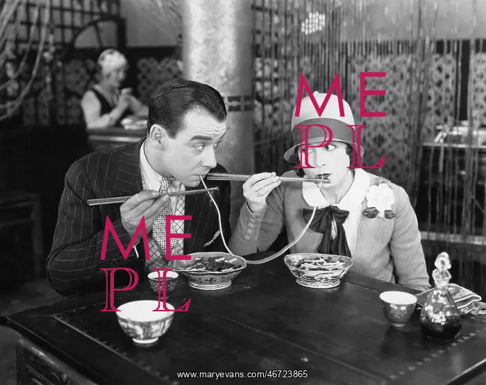 : Couple sharing a noodle in a restaurant : Couple sharing a noodle in a restaurant