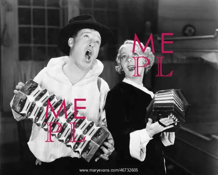: Couple singing while playing two accordions : Couple singing while playing two accordions