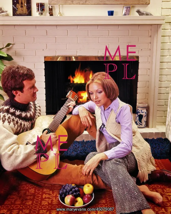 : Couple Sitting together by Brick Fireplace Man : Couple Sitting together by Brick Fireplace Man