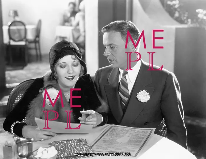  : A couple sitting together at a dinner table
