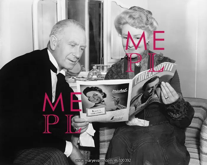  : Couple sitting together and looking at a magazine