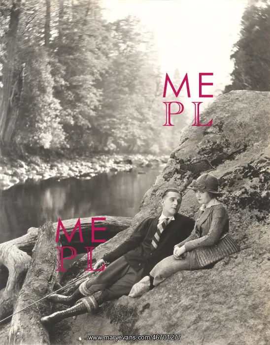: Couple sitting on rock beside stream : Couple sitting on rock beside stream