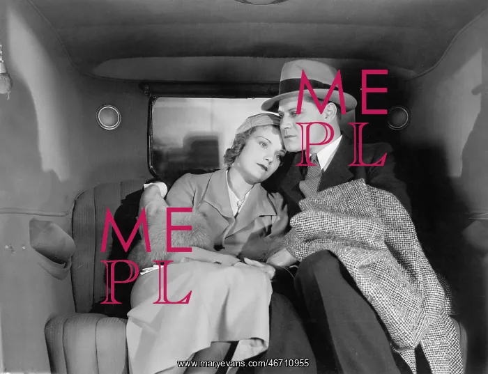 : Couple sitting together on the back seat of a car : Couple sitting together on the back seat of a car