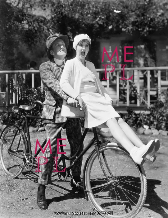 : Couple sitting on a tandem bicycle : Couple sitting on a tandem bicycle