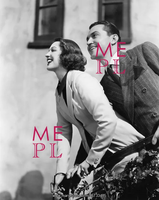 : Couple standing at a balcony and smiling : Couple standing at a balcony and smiling