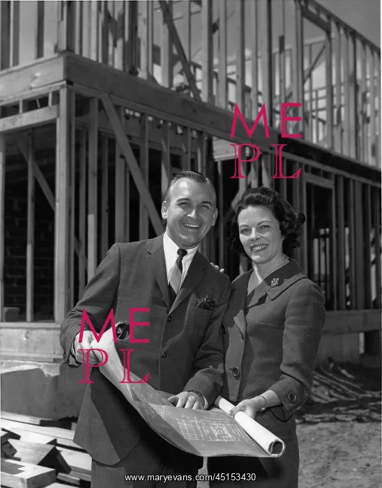 : Couple standing in front of under construction house : Couple standing in front of under construction house