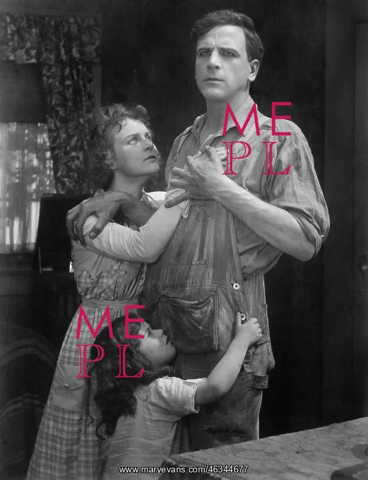 : Couple standing embraced with their daughter : Couple standing embraced with their daughter