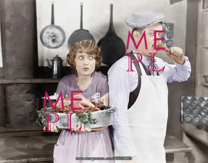 : Couple standing together in a kitchen with a cooked turkey : Couple standing together in a kitchen with a cooked turkey
