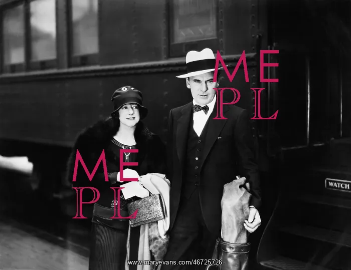 : Couple standing at a railroad station platform : Couple standing at a railroad station platform