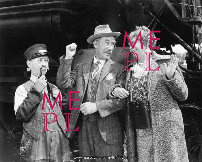  : Couple standing in front of a train with conductor