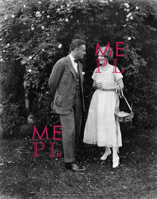 : Couple standing together in a yard looking at each other : Couple standing together in a yard looking at each other