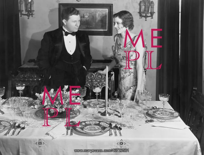 : Couple with table set for dinner : Couple with table set for dinner