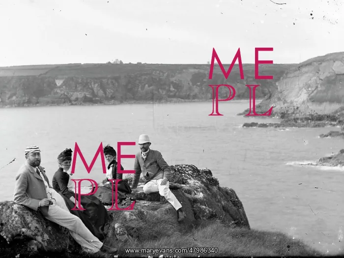 : Two couples sitting on a cliff top : Two couples sitting on a cliff top