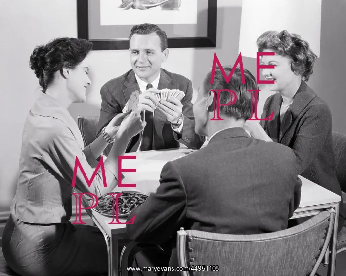 : Two Couples Sitting at Table Playing a : Two Couples Sitting at Table Playing a