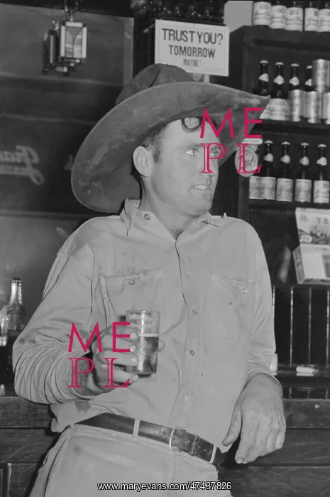 : Cowboy drinking beer in beer parlor, Alpine, Texas : Cowboy drinking beer in beer parlor, Alpine, Texas