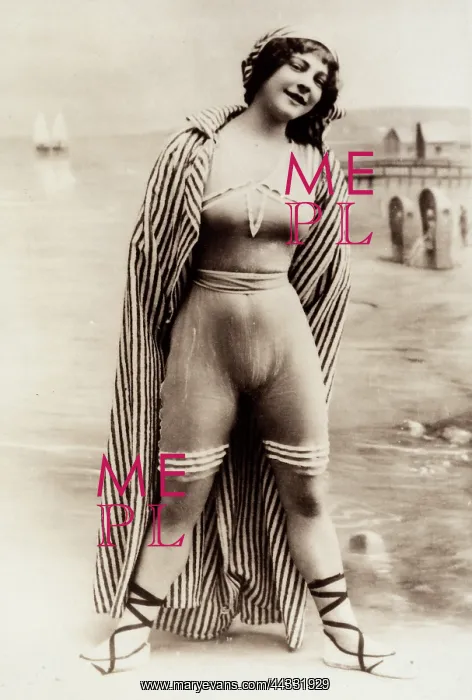 : Creative. Full-length portrait of a young woman at the water's edge of a beach : Creative. Full-length portrait of a young woman at the water's edge of a beach