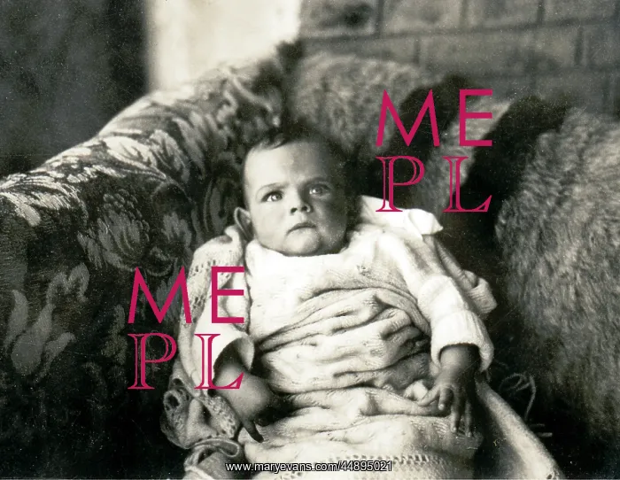 : Cross looking baby on a sofa : Cross looking baby on a sofa
