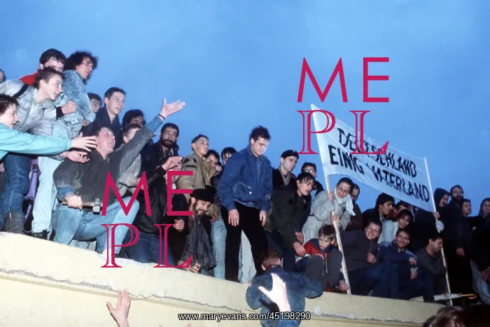 : A crowd celebrates atop the Berlin Wall ? : A crowd celebrates atop the Berlin Wall ?
