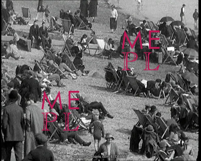 : A Crowd of Civilians Sitting On Deckchairs at the Beach : A Crowd of Civilians Sitting On Deckchairs at the Beach