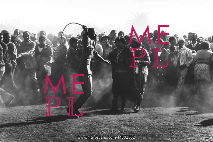 : Crowd control... a black policeman uses a sjambok : Crowd control... a black policeman uses a sjambok