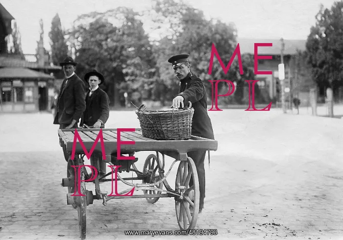 : A customs official checks a basket, 1907 : A customs official checks a basket, 1907