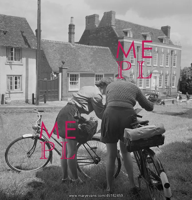 : Cyclists. Two female cyclists consult their map on Watling Street : Cyclists. Two female cyclists consult their map on Watling Street