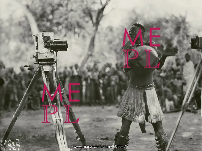 : Dancer with leg rattles and hand drum in front of : Dancer with leg rattles and hand drum in front of