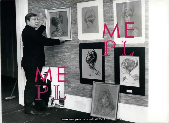 : Daniel Farson arranging Ward portraits : Daniel Farson arranging Ward portraits