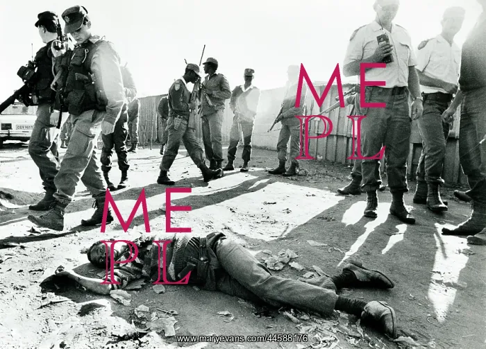 : The dead body of a young black man lies in the : The dead body of a young black man lies in the