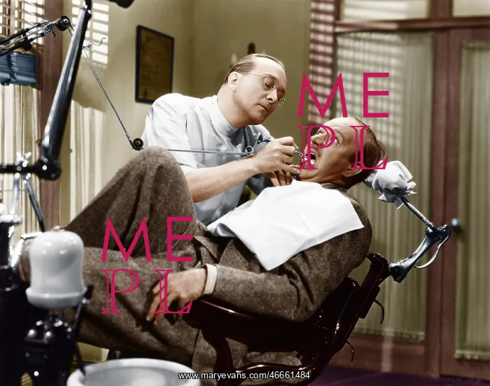 : A dentist working on a patient in the chair : A dentist working on a patient in the chair