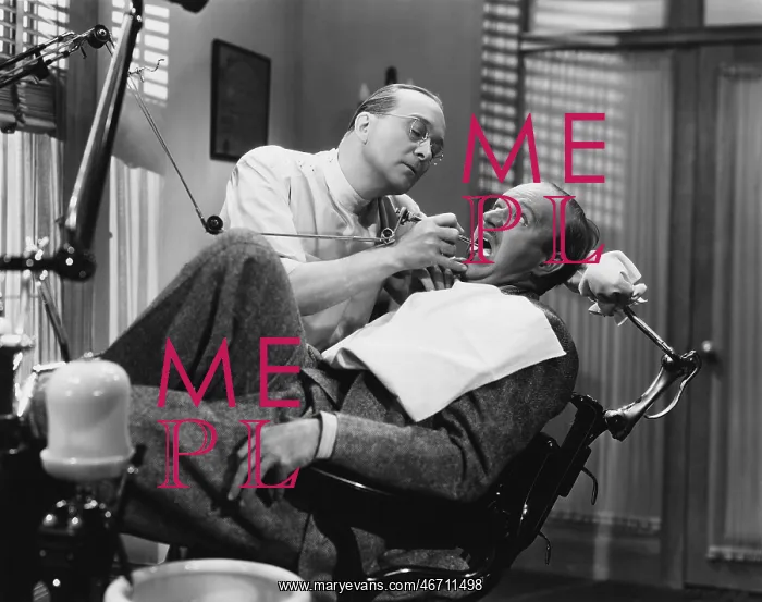 : A dentist working on a patient in the chair : A dentist working on a patient in the chair