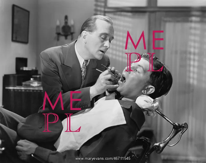 : A dentist working on a patient in the chair : A dentist working on a patient in the chair