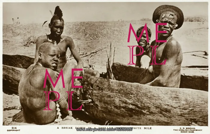 : Dinka Tribesmen in carved-out canoe : Dinka Tribesmen in carved-out canoe