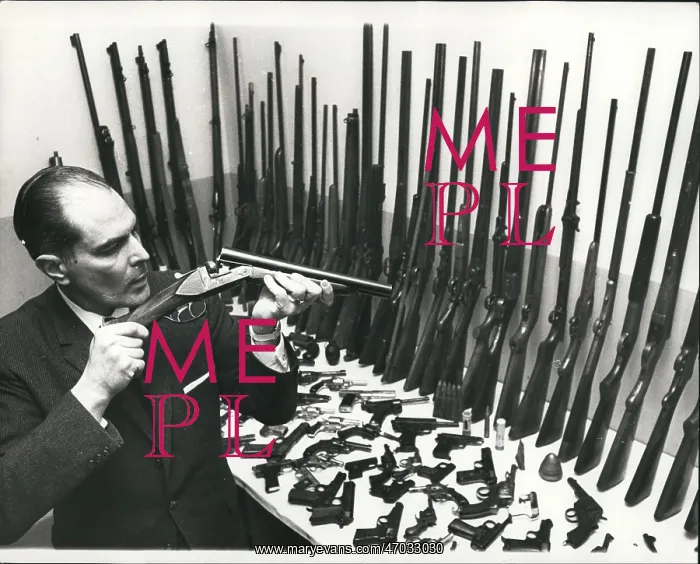 : Douglas Gomez, firearms expert, with amnesty guns, London : Douglas Gomez, firearms expert, with amnesty guns, London