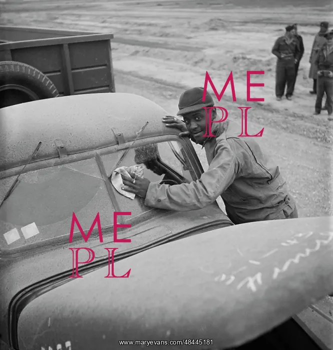 : The driver cleaning the desert dust off his : The driver cleaning the desert dust off his