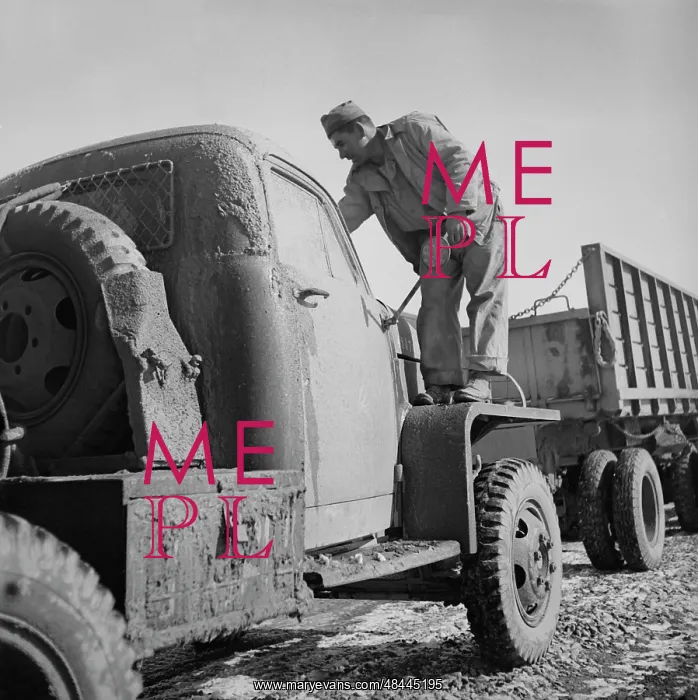 : The driver is cleaning mud from the windshield : The driver is cleaning mud from the windshield