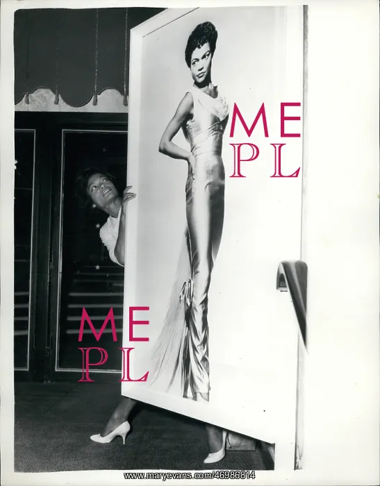 : Eartha Kitt, singer, with large portrait, Talk of the Town : Eartha Kitt, singer, with large portrait, Talk of the Town
