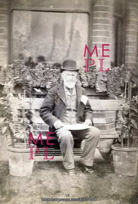 : Elderly gardener taking a break on a garden bench : Elderly gardener taking a break on a garden bench