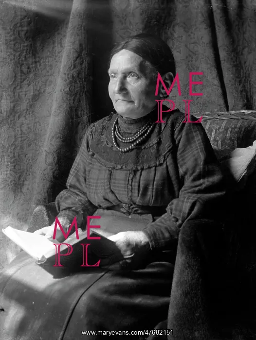  : Elderly lady sitting and reading a book