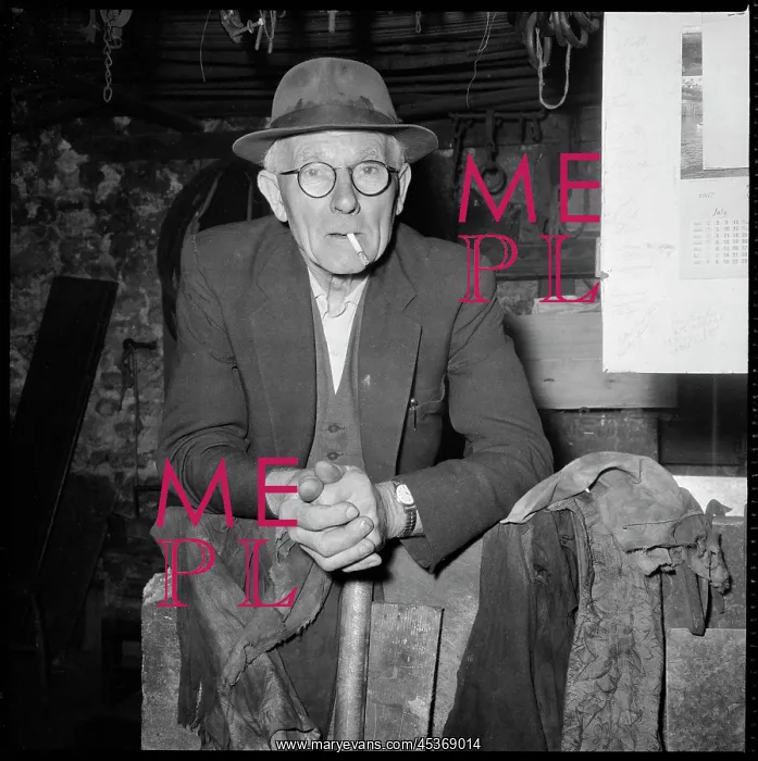 : An elderly man posed in a workshop, possibly a : An elderly man posed in a workshop, possibly a