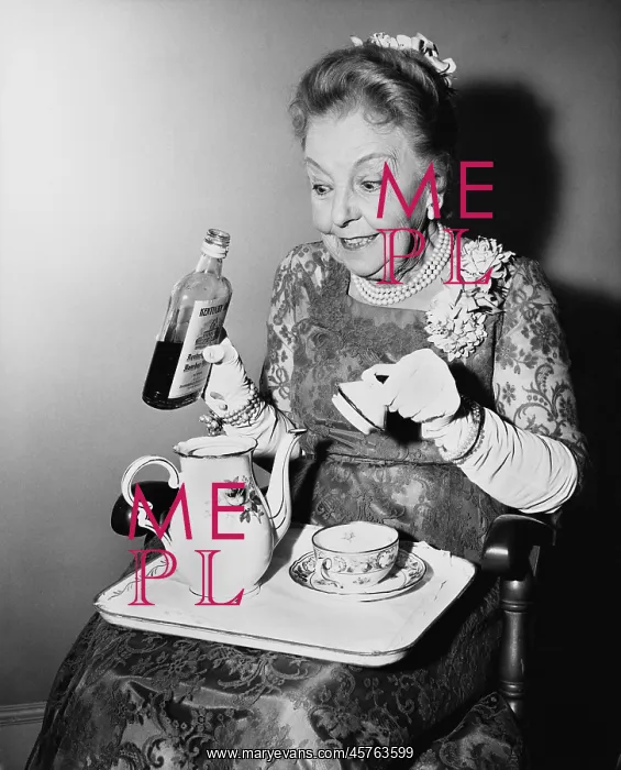 : Elderly woman spiking her tea : Elderly woman spiking her tea
