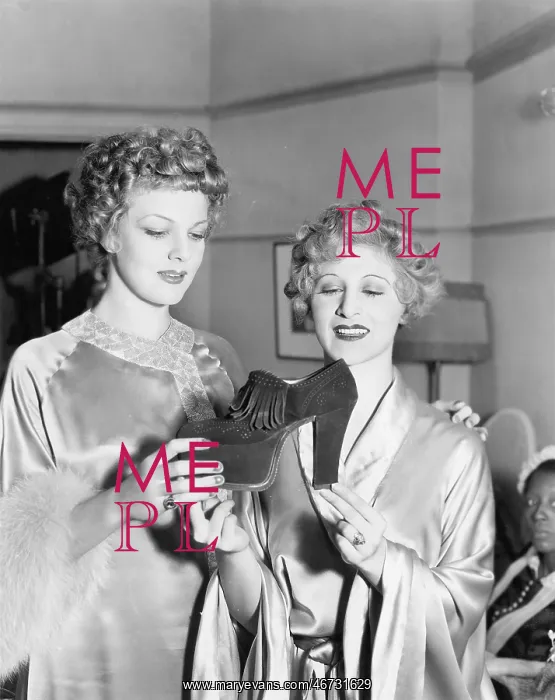 : Two elegant women looking at platform shoe : Two elegant women looking at platform shoe