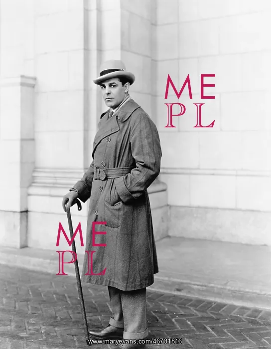 : Elegantly dressed man standing in front of a building : Elegantly dressed man standing in front of a building