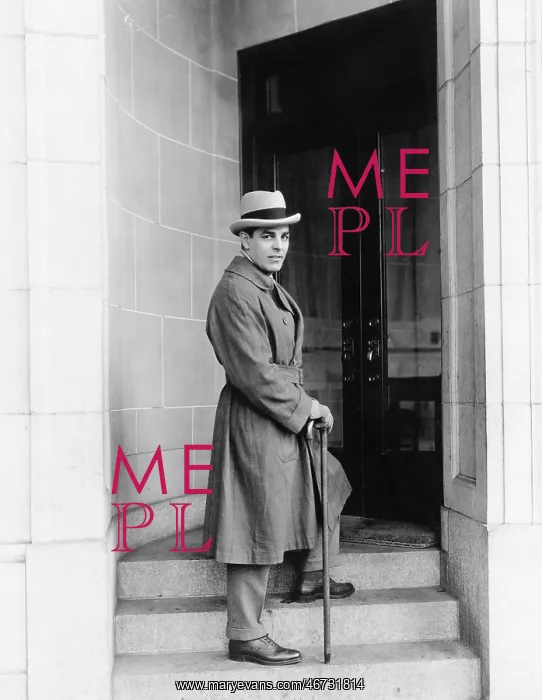 : Elegantly dressed man standing in a door way of an office : Elegantly dressed man standing in a door way of an office