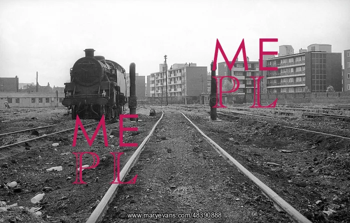 : Nine Elms Loco Yard with steam engine and flats beyond : Nine Elms Loco Yard with steam engine and flats beyond