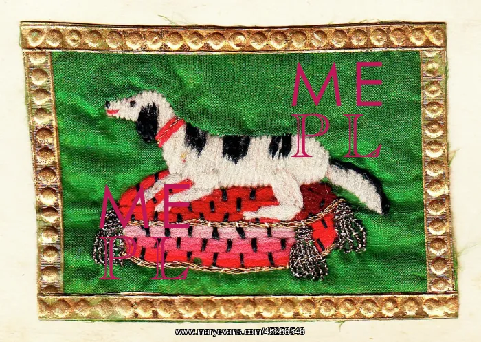: Embroidered dog on a cushion with gold edging : Embroidered dog on a cushion with gold edging