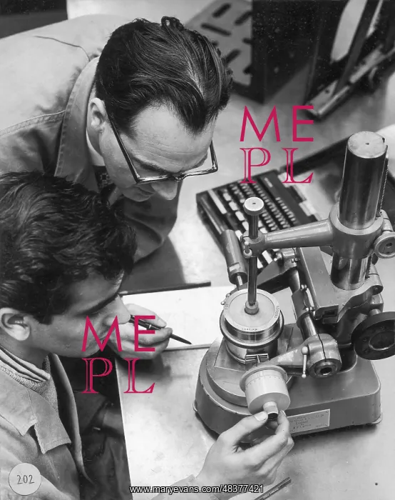 : Two engineers using a measurement device : Two engineers using a measurement device