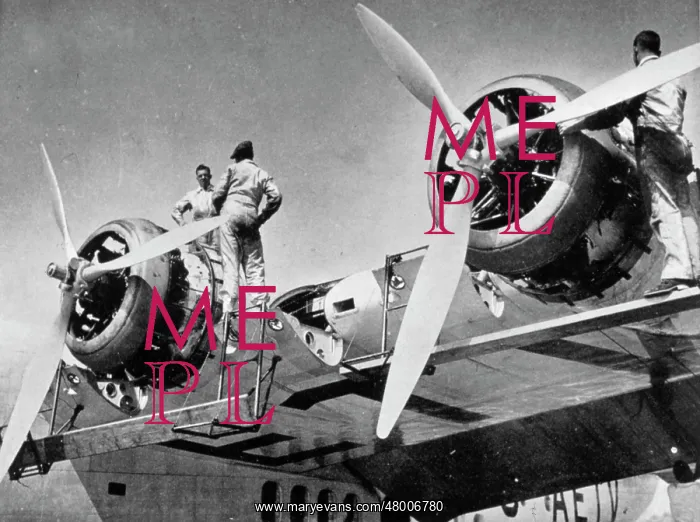 : Engineers working on aeroplane engines : Engineers working on aeroplane engines